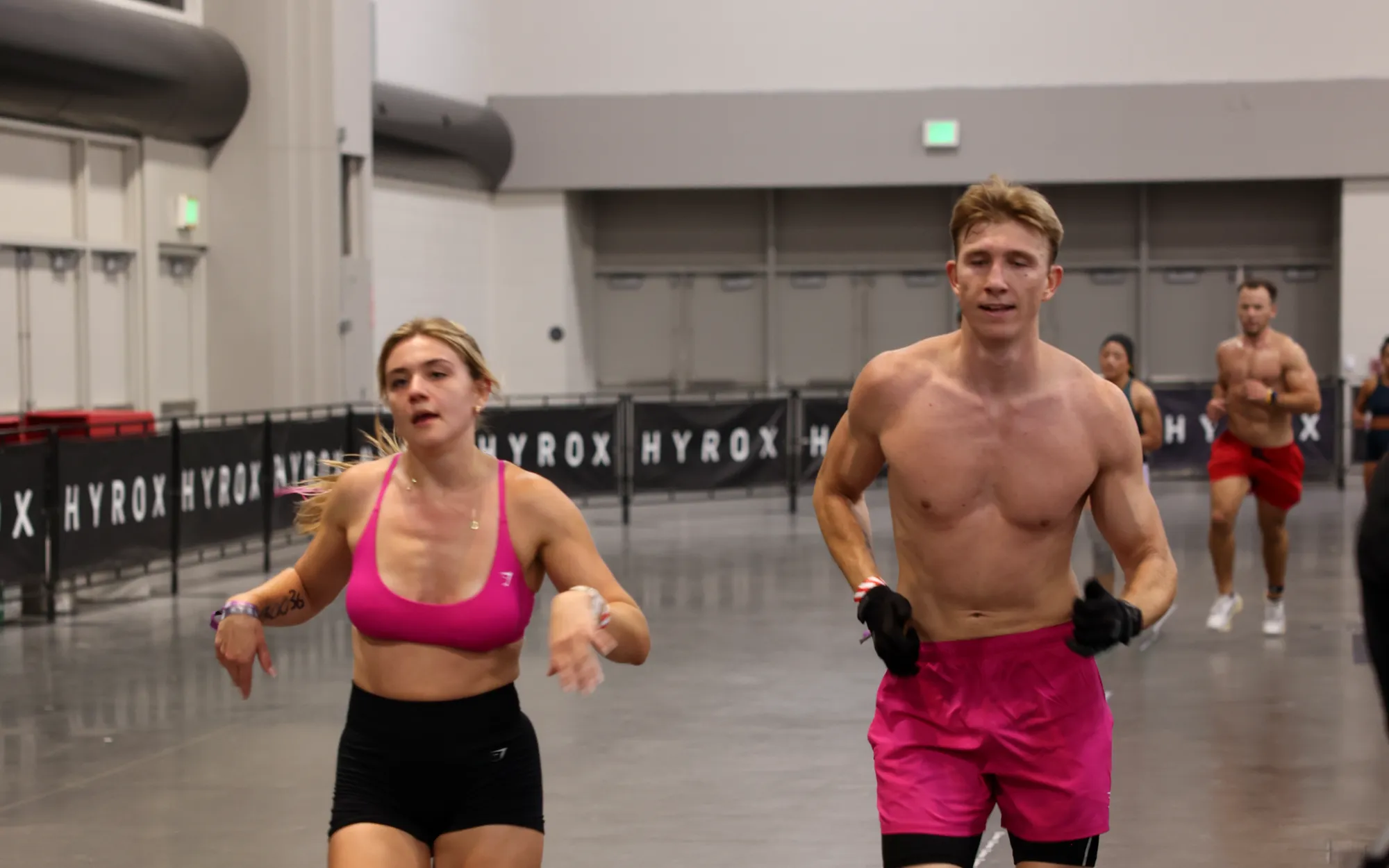 A doubles team running side by side between stations at HYROX Salt Lake City
