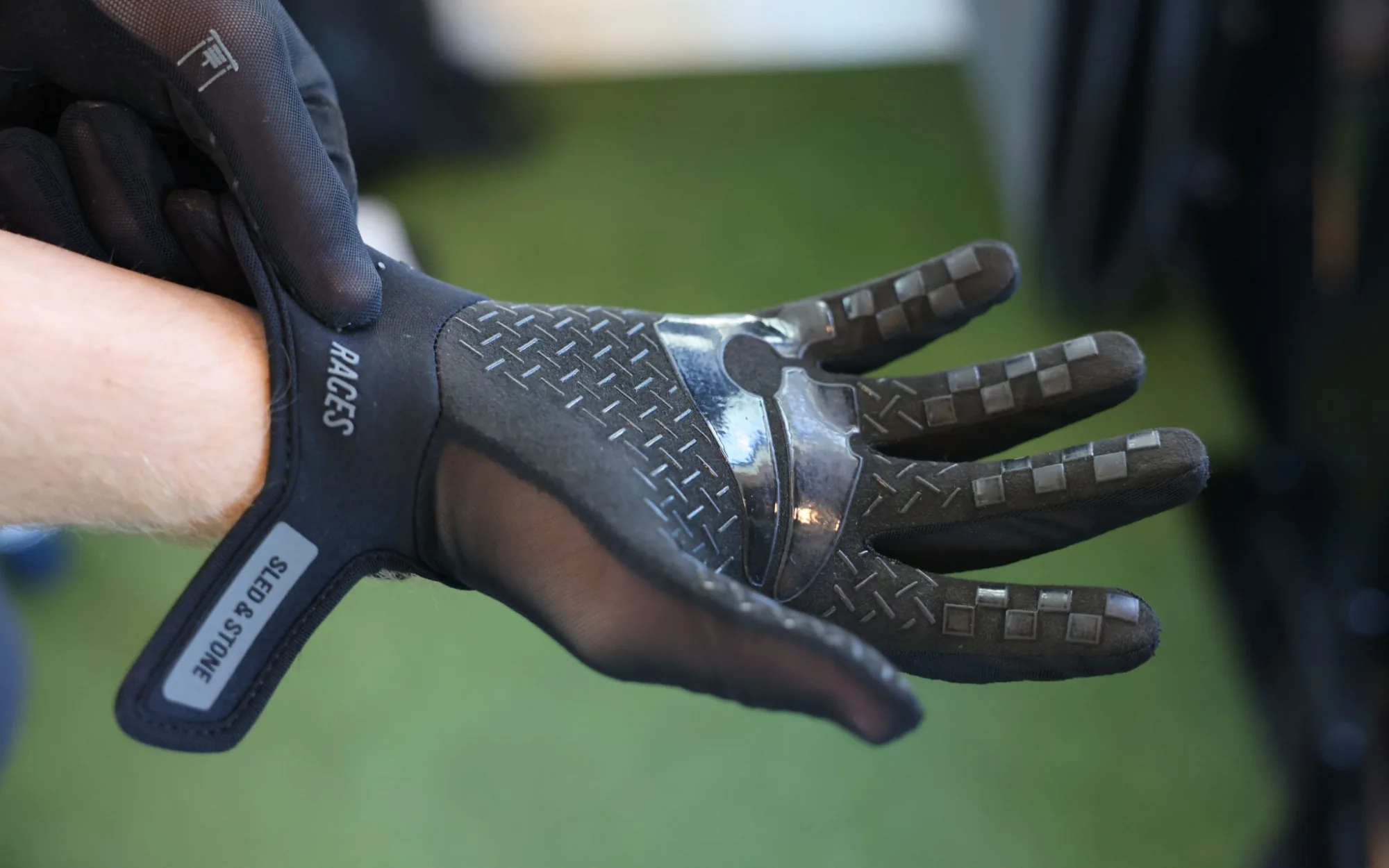 The palm of the glove held open: diamond-tread silicone and checkerboard fingertips