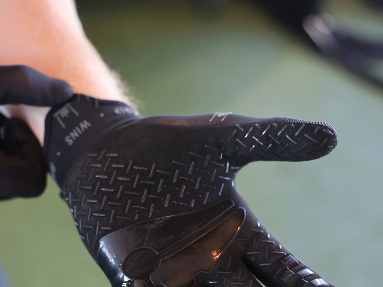 Richard Taylor racing in the Sled & Stone glove, gripping the sandbag on the lunges — view 4