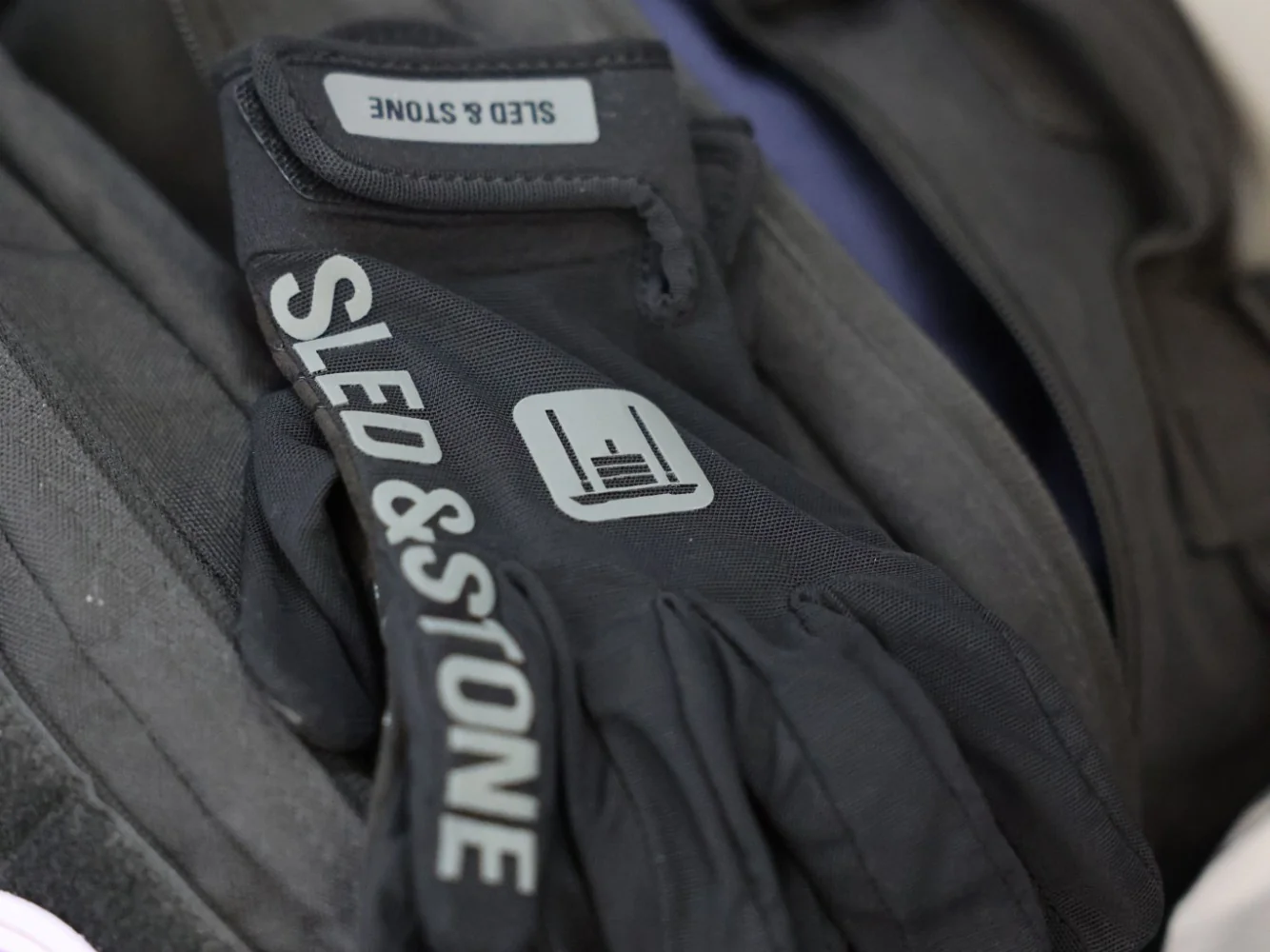 Richard Taylor racing in the Sled & Stone glove, gripping the sandbag on the lunges — view 2