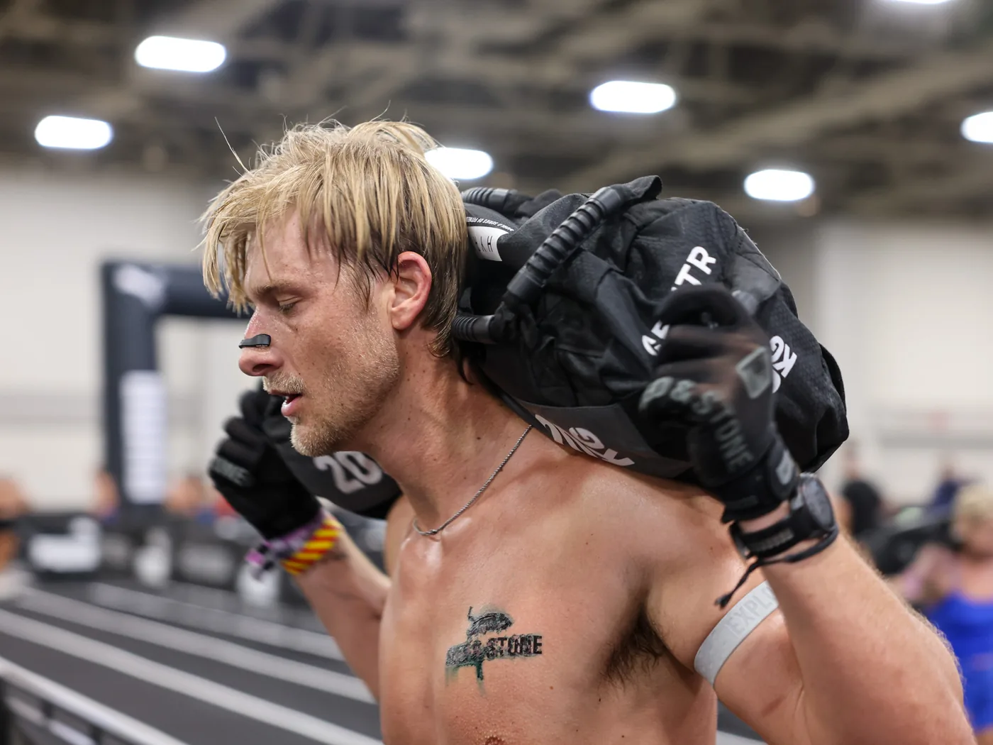 Richard Taylor racing in the Sled & Stone glove, gripping the sandbag on the lunges
