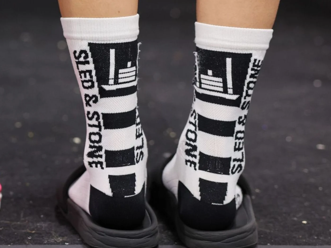 The Updraft race sock in white with black, Sled & Stone knitted down the cuff — view 3
